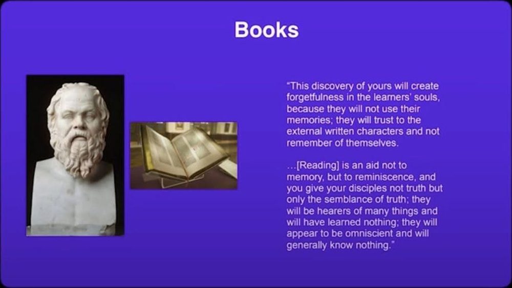 The slide from MindMax setting the Phaedrus passage against a picture of a book. Its bracketed word reads "Reading", where Plato's text has the invention of writing.